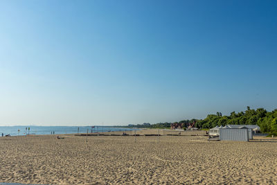 Scenic view of beach against clear blue sky