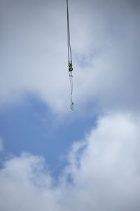 Low angle view of crane against sky