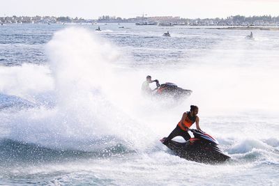 People surfing in sea