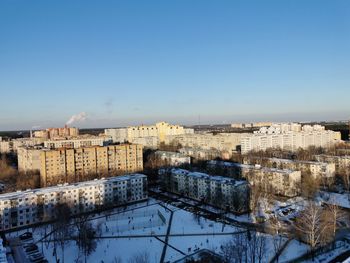 High angle view of buildings in city against clear sky