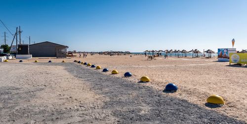 Scenic view of beach against clear blue sky