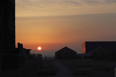 Built structure against sunset sky