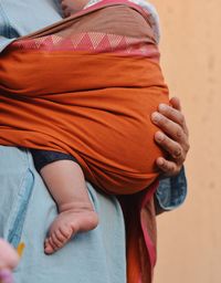 Midsection of man carrying child