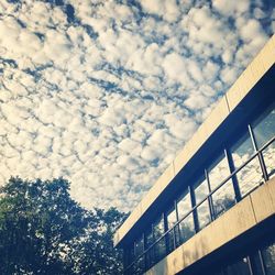 Low angle view of building against cloudy sky