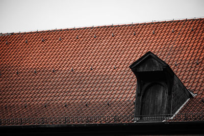 Low angle view of house roof against sky