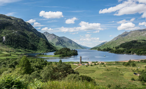 Scenic view of lake and mountains against sky