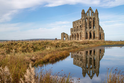 Reflection of whitby abbey on water