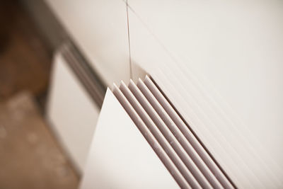 Close-up of open book against wall