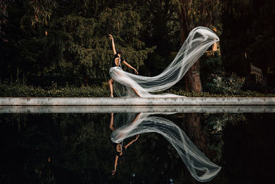 Young professional dancer posing by the water