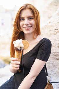 Cheerful teen female with ice cream cone