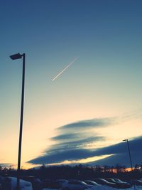 Vapor trail in sky at sunset