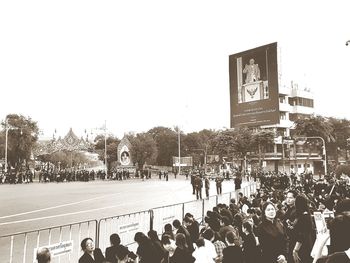 People on street against clear sky