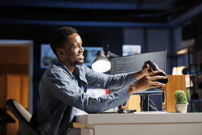 Side view of man using mobile phone