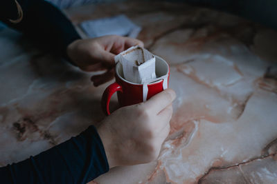 In a red mug homemade coffee filter, alternative brewing of the drink