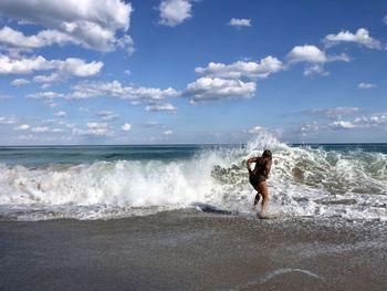 Full length of man on beach against sky