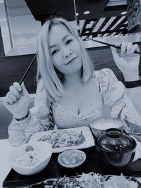 Portrait of girl with ice cream on table