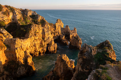 Scenic view of sea and rocks against sky