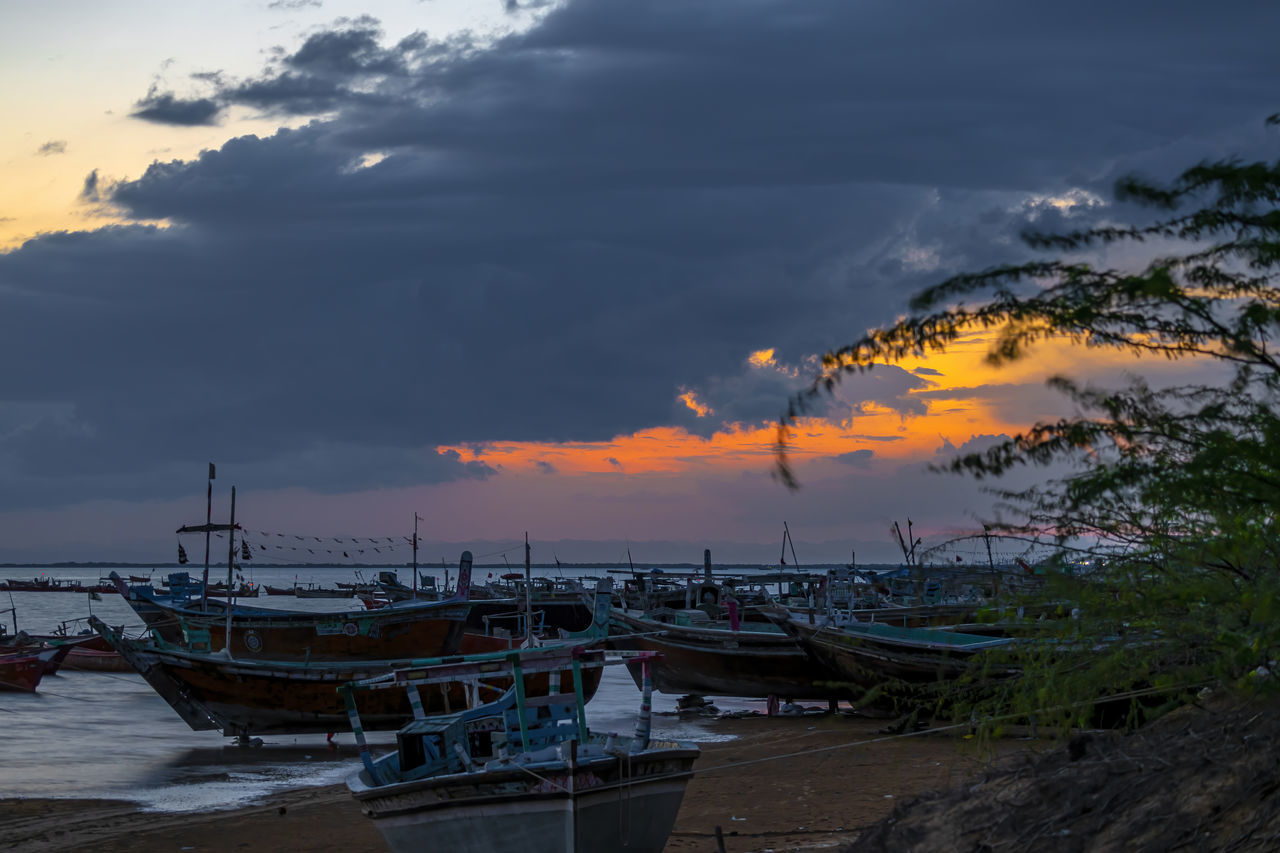 sky, cloud, water, nautical vessel, transportation, sea, sunset, nature, mode of transportation, beach, coast, beauty in nature, land, evening, scenics - nature, shore, ocean, reflection, dusk, no people, tranquility, moored, travel, environment, travel destinations, ship, vehicle, outdoors, boat, fishing, tree, dramatic sky, harbor, tranquil scene, landscape, holiday, plant, tourism, horizon, architecture, vacation, tropical climate, pier, trip, seascape, sun, wave, watercraft