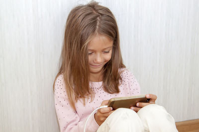 Girl looking away while sitting on camera