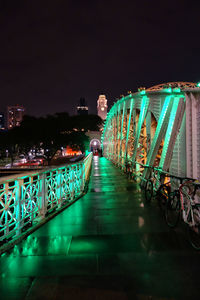 Illuminated bridge against sky at night