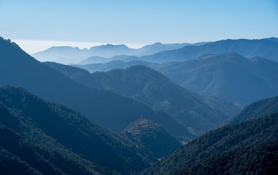 The beauty of the blue tinted mountains diminishing into the distnace on a hazy morning.