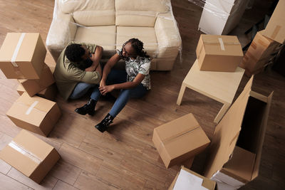 High angle view of woman with cardboard box