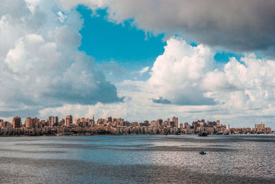 Panoramic view of sea and buildings against sky