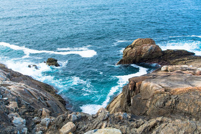 High angle view of rock formation by sea