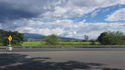 Empty road with mountains in background