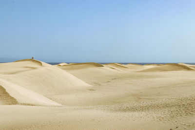 Scenic view of desert against clear sky