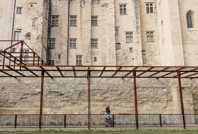 Man standing by old building in city