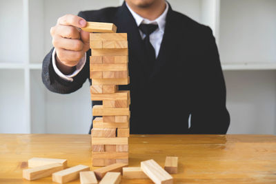 Midsection of man standing on table