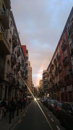 City street against sky during sunset