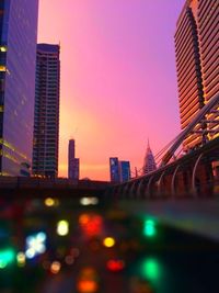 Modern buildings in city at sunset