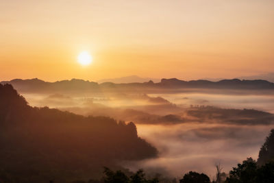 Scenic view of silhouette mountains against sky during sunset