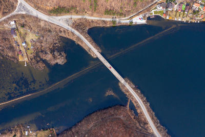 Aerial view of a bridge crossing a lake from a drone