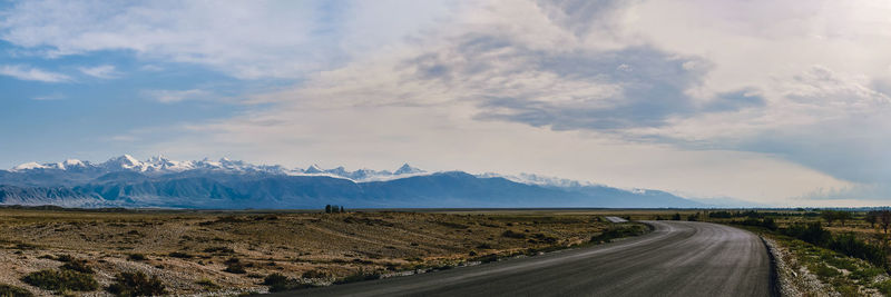 Road by landscape against sky