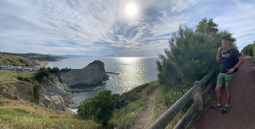 Man standing by sea against sky