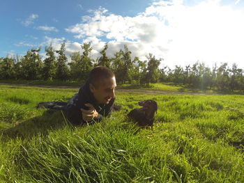 People relaxing on grassy field