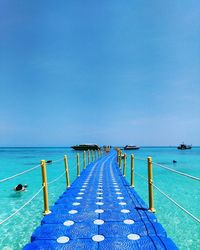 View of swimming pool by sea against clear sky