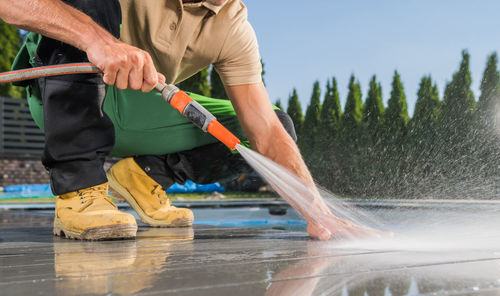 Low section of man working in lake