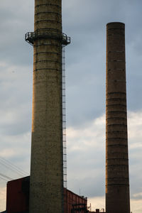 Low angle view of smoke stack against sky