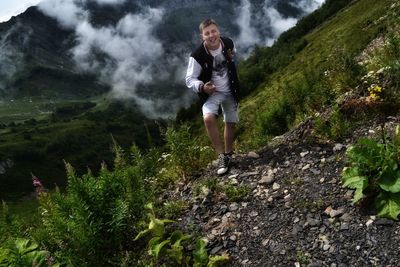 Full length of young man running on mountain