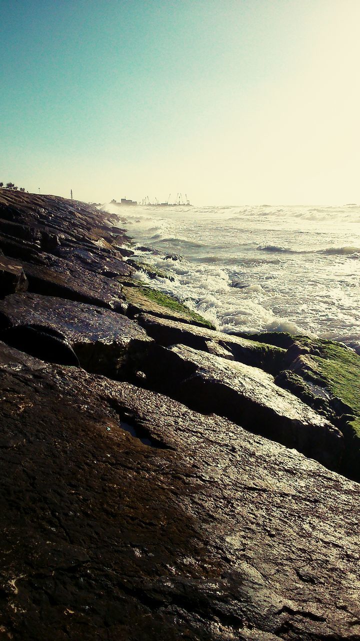 water, tranquil scene, tranquility, clear sky, scenics, sea, beauty in nature, beach, nature, copy space, shore, sand, horizon over water, idyllic, non-urban scene, remote, sky, outdoors, landscape, coastline