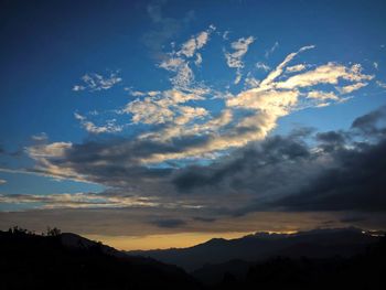 Low angle view of silhouette mountains against sky at sunset