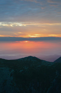 Scenic view of silhouette mountain against sky during sunset