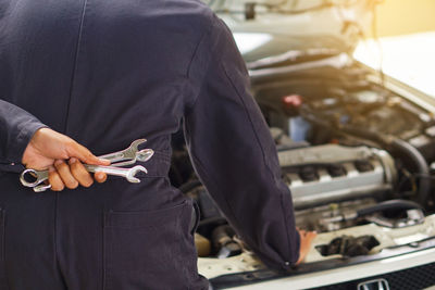 Midsection of man working at bus