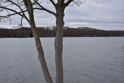 Scenic view of lake against sky during winter