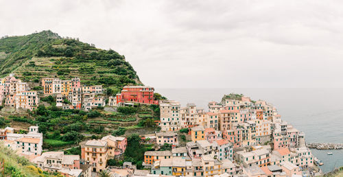 High angle view of townscape by sea against sky