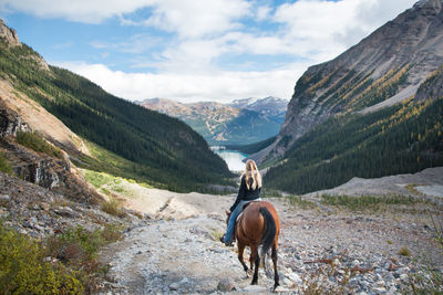 Horse riding horses on mountain landscape